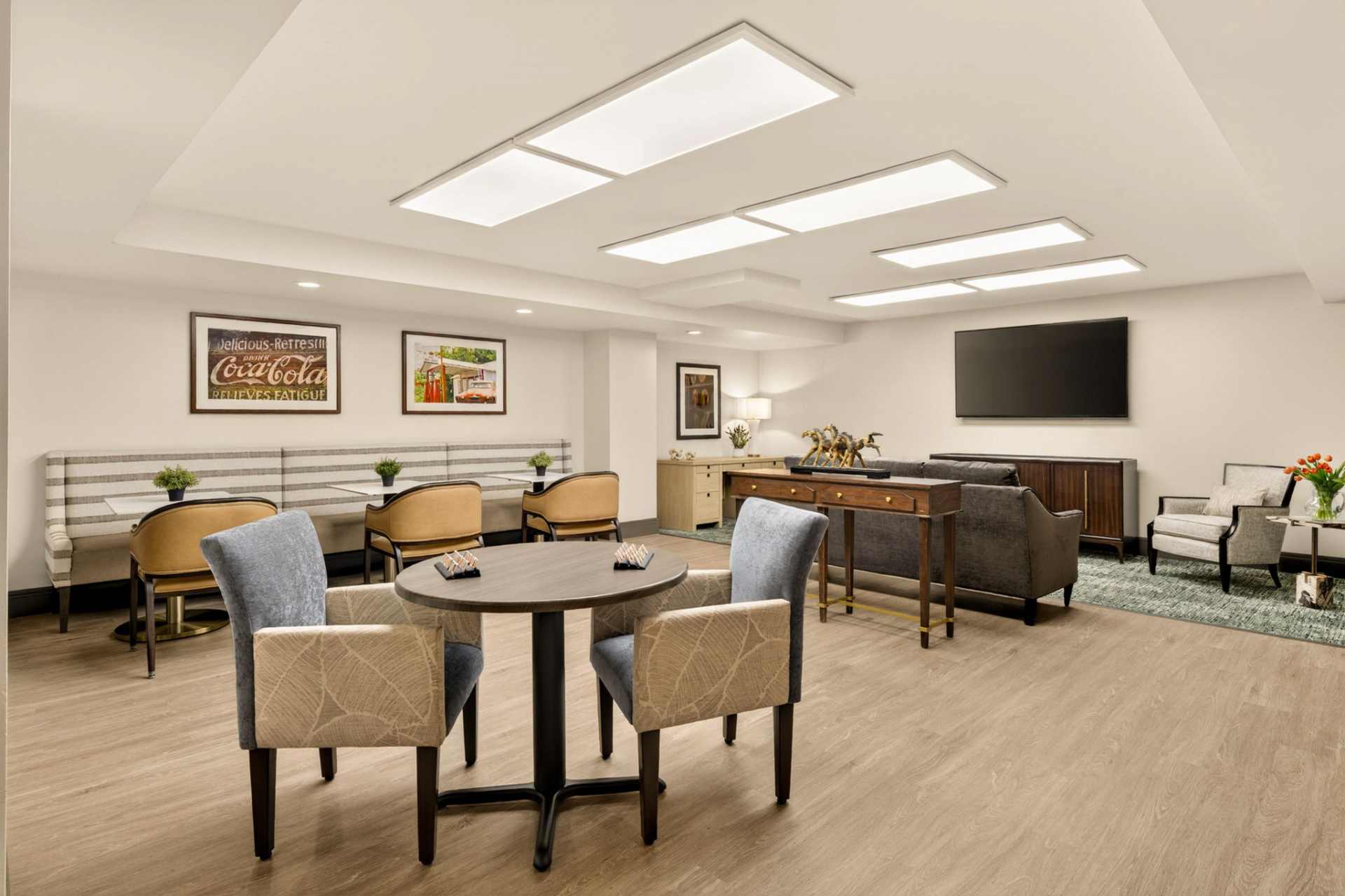 An activity room with a TV and a game table
